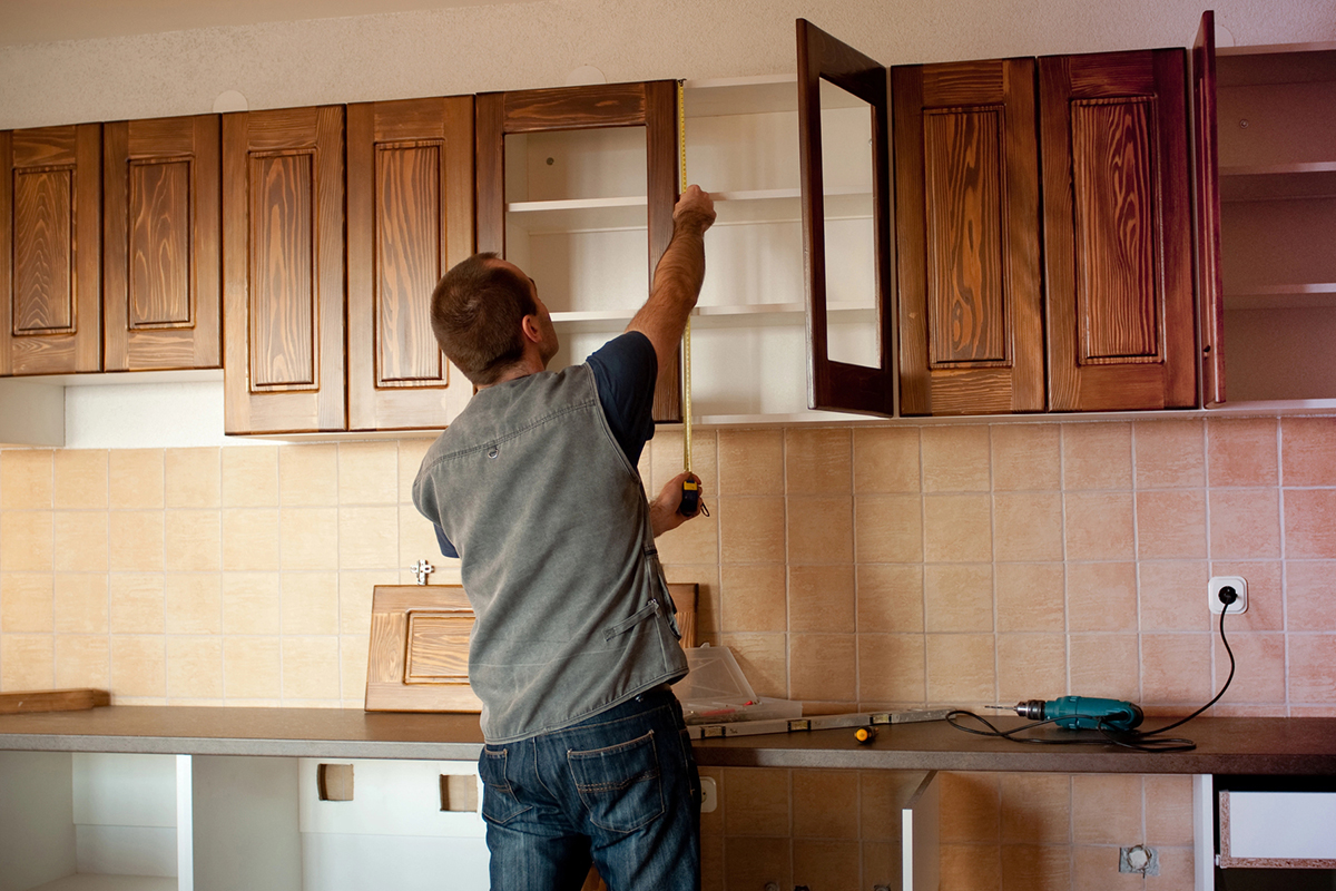 contractor measuring cabinets during Design Build Remodeling In Scottsdale, Paradise Valley, Surprise, AZ, Peoria, AZ, Glendale, AZ, and the Surrounding Areas